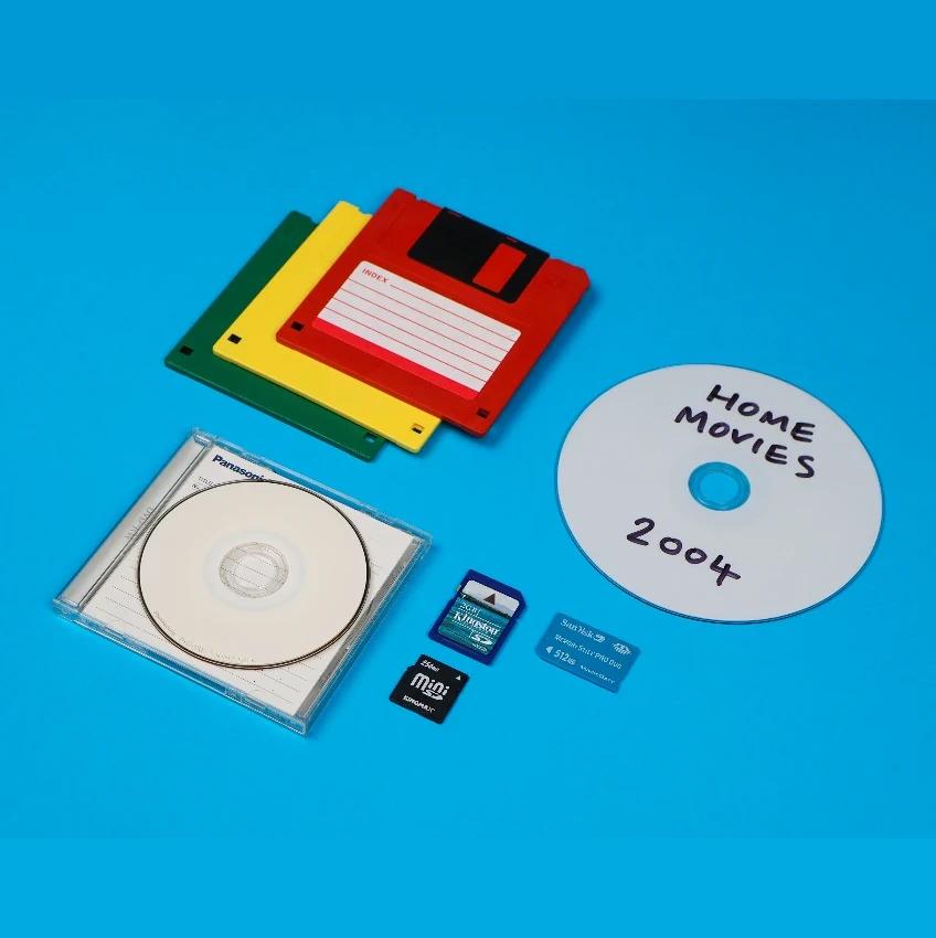 Discs, floppy disks and memory cards on a blue background